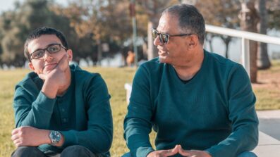 Teenage boy with Dad sat outside